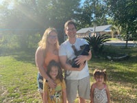 a man, woman, and two children posing for a picture